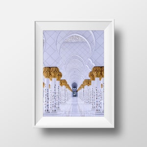 May include: A white hallway with a series of arches and columns. The columns are decorated with gold accents and intricate patterns. The hallway leads to a doorway at the end.