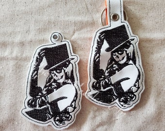 Diseño de la máquina de bordar de un llavero de la señora del cráneo, así como un archivo de la pestaña de la presión incluido