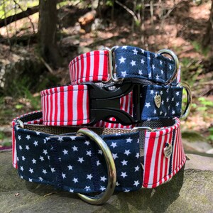 May include: Three patriotic dog collars stacked on top of each other. The top collar has a red and white striped pattern. The middle collar has a navy blue star pattern. The bottom collar has a navy blue star pattern and a red and white striped pattern.