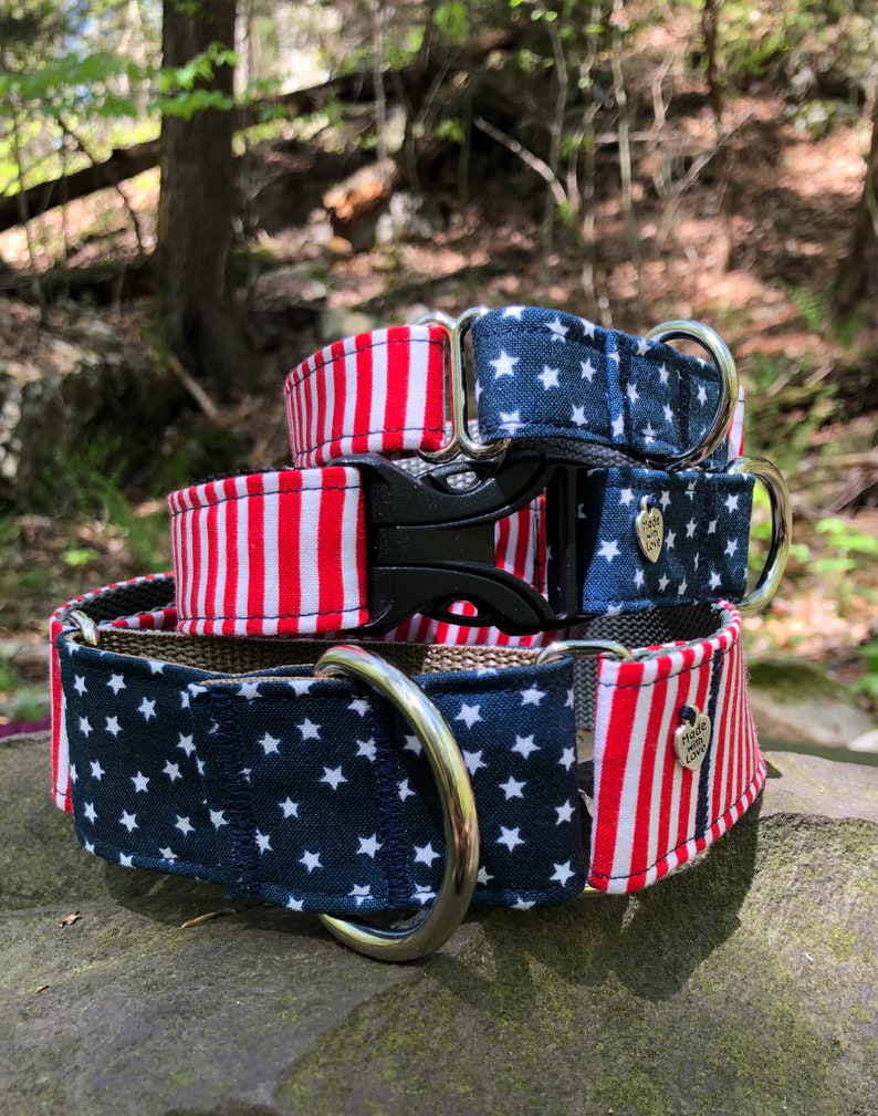 May include: Three patriotic dog collars stacked on top of each other. The top collar has a red and white striped pattern. The middle collar has a navy blue star pattern. The bottom collar has a navy blue star pattern and a red and white striped pattern.