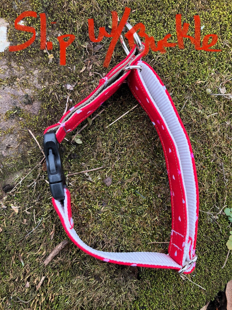 May include: Red dog collar with white hearts printed on it. The collar is made of a soft, durable fabric and has a silver metal slip buckle.