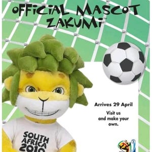 May include: A Build-A-Bear Workshop advertisement featuring the official mascot Zakumi, a plush lion with green hair and a white t-shirt that says "South Africa 2010". A soccer ball is also shown. The text says "Arrives 29 April".