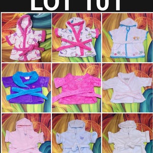 May include: A collection of nine children's bathrobes in various colors and designs. The robes include pink, purple, blue, and white options, some featuring cartoon characters and embroidered details. The text "LOT 101" is at the top.