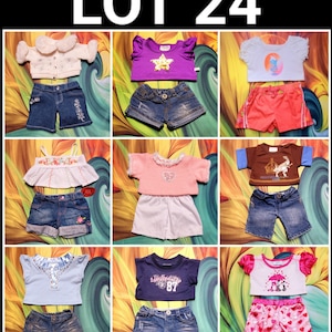 May include: A collection of doll clothes sets, including tops and shorts. The tops are various colors, such as purple, pink, and blue, with decorative elements like ruffles, embroidery, and graphic prints. The shorts are denim and pink with heart patterns. The text "LOT 24" is at the top.
