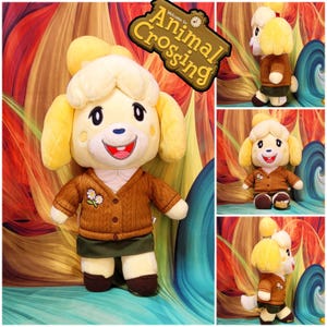 May include: A plush toy of the character Isabelle from Animal Crossing, featuring yellow fur, a brown cable-knit cardigan with a white flower embroidery, a dark green skirt, and brown shoes. The toy has a wide smile and a white tuft of hair.