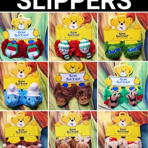 May include: A variety of children's slippers, each with a unique design. Styles include snowmen, turtles, Smurfs, bears, reindeer, and deer. Each pair is displayed with a yellow tag that reads "Bear Boutique" and a bear illustration.