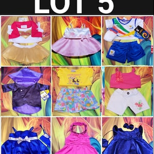 May include: A collection of children's clothing sets, including dresses, tops, and shorts. The sets feature various colors like pink, blue, yellow, and white. Some outfits have decorative bows and floral accents. The image includes the text "LOT 5".