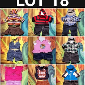 May include: A collection of doll clothing sets, including tops, shorts, skirts, and hooded jackets. The outfits feature various colors and patterns, such as stripes, plaid, and argyle. The text "LOT 18" is visible at the top of the image.