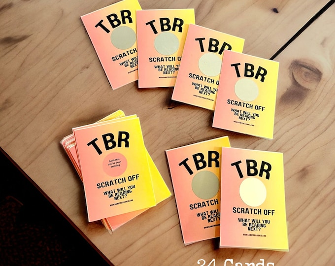 May include: A collection of TBR scratch-off cards with a gradient pink and yellow design. Each card has a scratch-off circle and the text "SCRATCH OFF WHAT WILL YOU BE READING NEXT?" The image also includes the text "24 Cards + 8 Blank Cards."