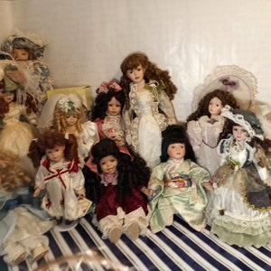 Lot 677: 27 Miniature China & Bisque Dolls w/ 3 Figures