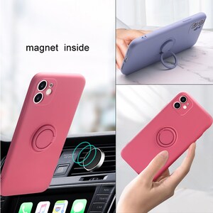 May include: A pink silicone phone case with a built-in ring holder and a magnetic plate on the back. The case is shown attached to a magnetic car mount.