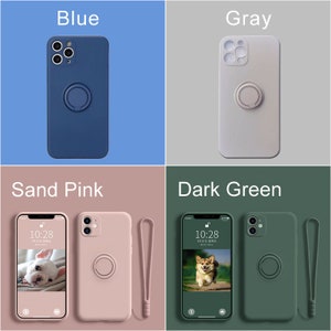 May include: Four iPhone cases with a ring holder and a wrist strap. The cases are in blue, gray, sand pink, and dark green.