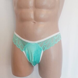 May include: Mint green lace underwear with white trim and a polka dot pattern.