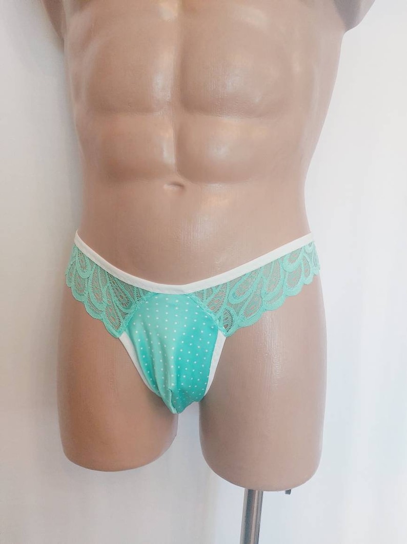 May include: Mint green lace underwear with white trim and a polka dot pattern.