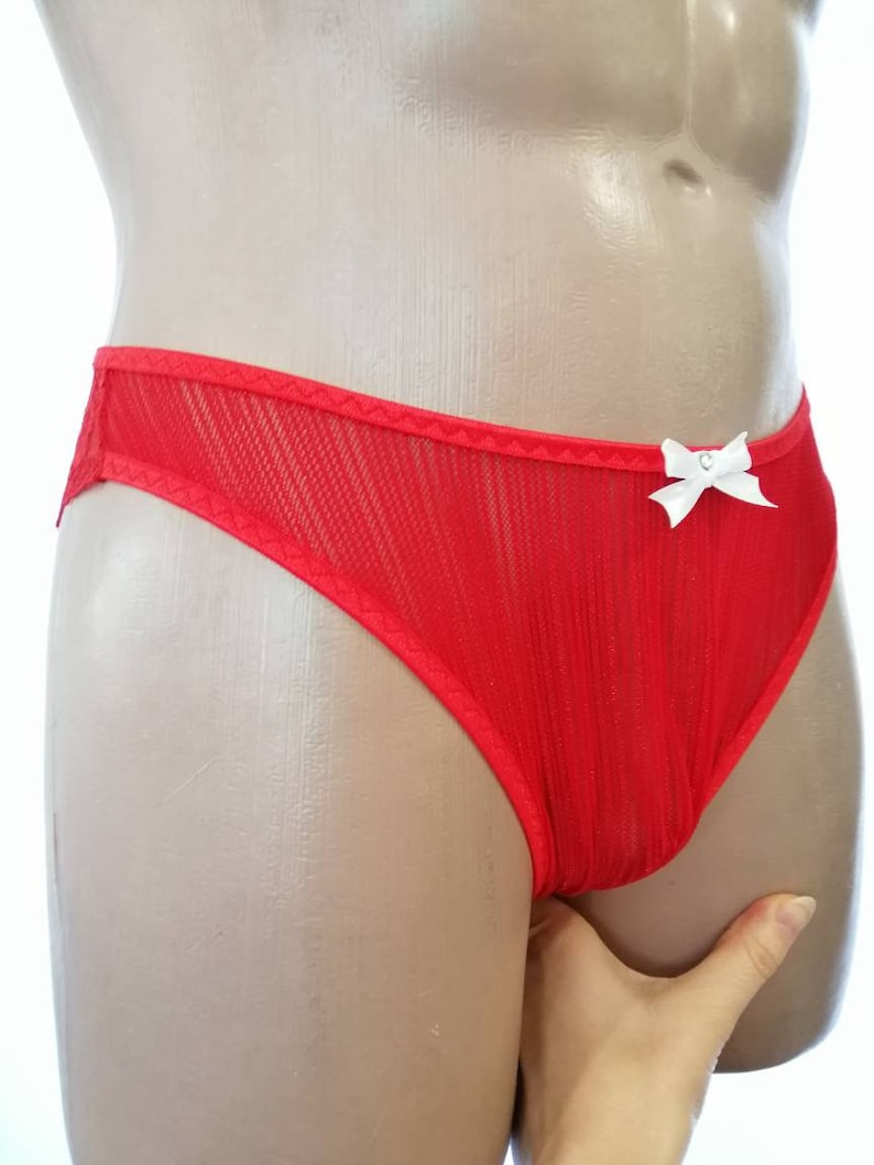 May include: Red mesh underwear with a white bow on the front.
