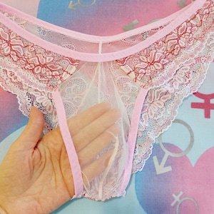 May include: Pink lace underwear with a white mesh lining and red floral embroidery.