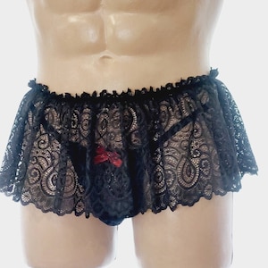 May include: Black lace underwear with a ruffled trim and a red bow detail.