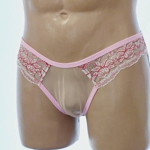 May include: Pink and white lace underwear with a sheer mesh panel. The underwear features a delicate floral pattern.