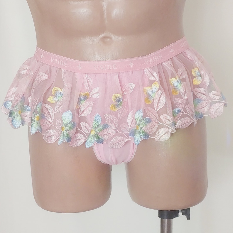 May include: Pink lace underwear with floral embroidery and the word "Vaide" repeated on the waistband.