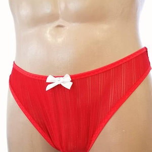 May include: Red mesh underwear with a white bow. The underwear has a ribbed texture.