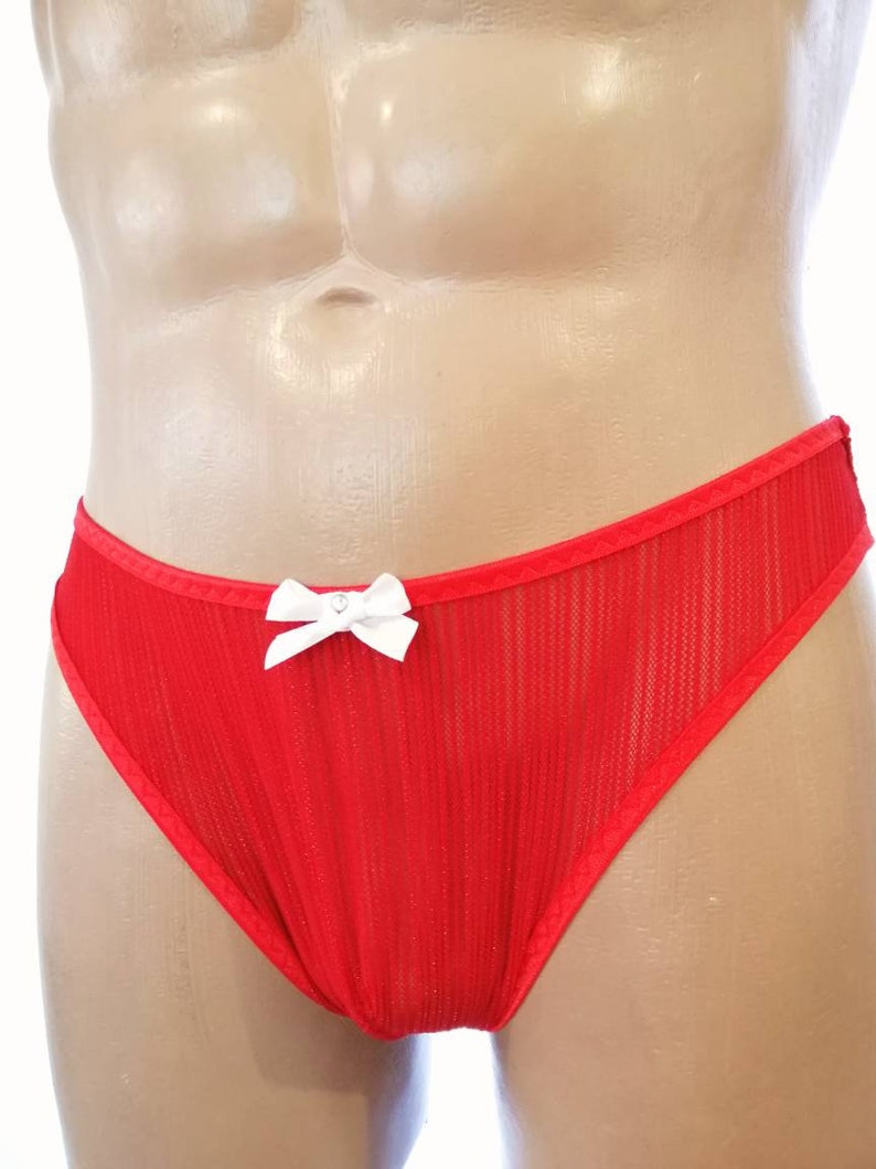May include: Red mesh underwear with a white bow. The underwear has a ribbed texture.