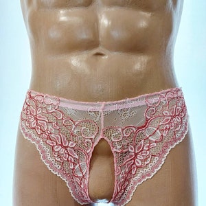 May include: Pink and red lace underwear with an open front design. The delicate floral lace trim and open design create a unique look. The underwear is displayed on a mannequin.