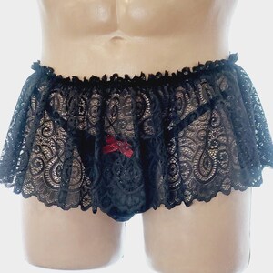 May include: Black lace lingerie with a ruffled trim and a red bow detail.
