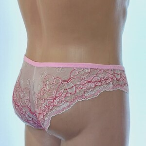 May include: Pink and white lace underwear with a floral design.