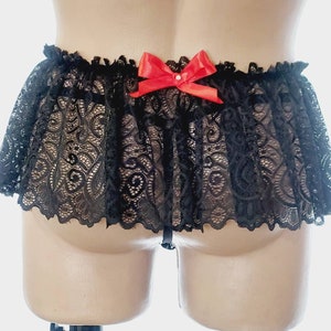 May include: Black lace lingerie with a red bow on the back.