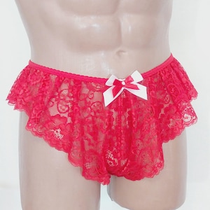 May include: Red lace underwear with a white bow. The underwear has a ruffled edge.