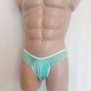 May include: Light blue lace underwear with white trim and a polka dot pattern.