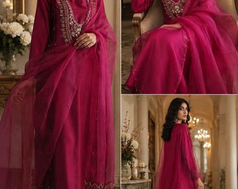 May include: A magenta long-sleeved tunic and matching trousers set featuring intricate embroidery around the neckline and cuffs. The outfit includes a sheer, lightweight magenta dupatta draped over the shoulders, adorned with delicate beadwork details.