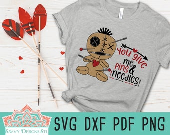 May include: A gray t-shirt with a voodoo doll graphic and the text "You give me pins & needles".