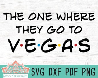 May include: Black and white text graphic that reads "The One Where They Go To V.E.G.A.S." with a red dot after the V, a blue dot after the E, a yellow dot after the G, and a red dot after the A. The graphic is on a white wood background.