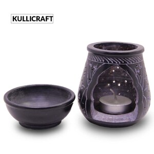 Puede incluir: Quemador de aceite de piedra negra con tallas intrincadas y un taz&oacute;n peque&ntilde;o para aceites esenciales. El quemador tiene un agujero para una vela de t&eacute;.