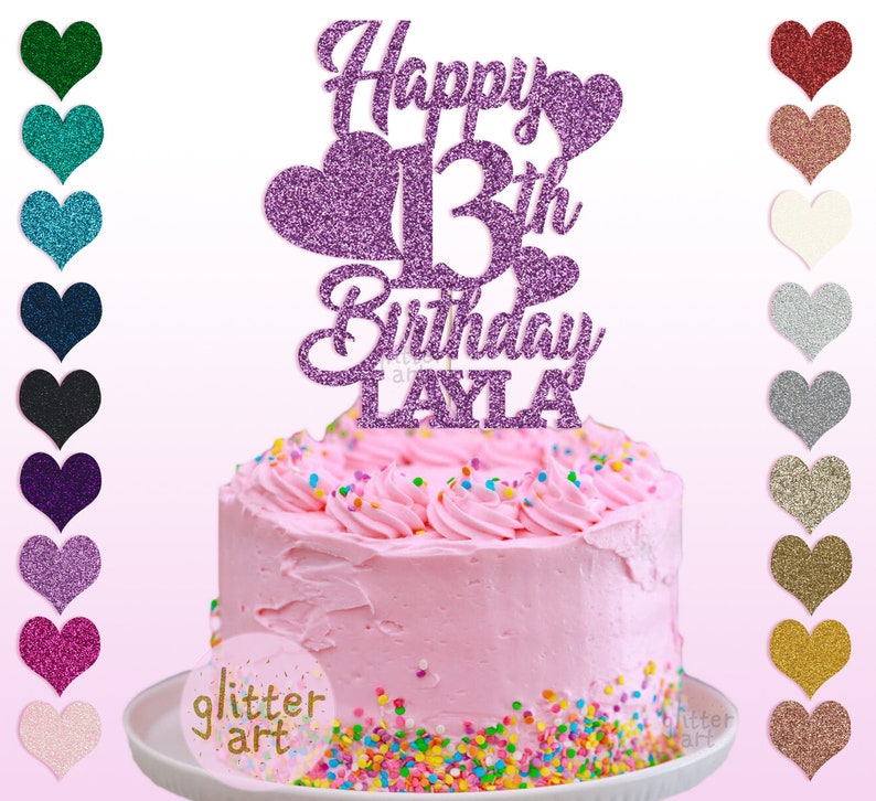 Pu&ograve; includere: Topper per torta di glitter viola con il testo "Happy 13th Birthday Layla". Il topper presenta un grande numero 13 e due cuori. Il topper &egrave; posto su una torta glassata rosa con codette colorate.