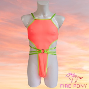 May include: A bright pink one-piece swimsuit with neon green trim and straps. The swimsuit has a cut-out design and a ring detail at the waist.
