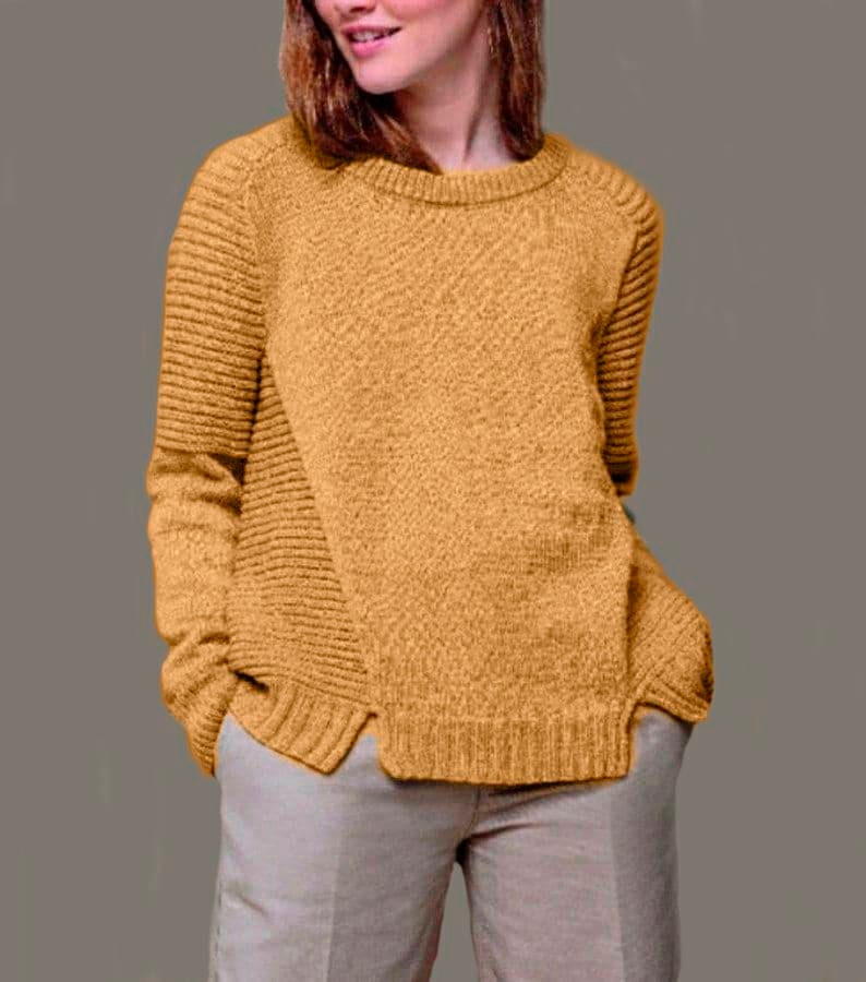 May include: A mustard yellow sweater with a ribbed texture and a slightly asymmetrical hem.