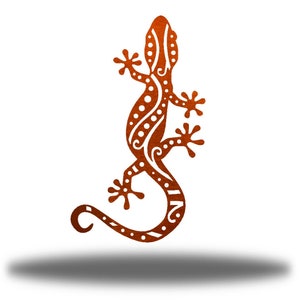 May include: A stylized orange gecko with white dots and swirls. The gecko is in a standing position with its tail curled around its body.