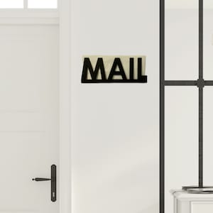 May include: Black metal mail holder with the word "MAIL" in large letters.