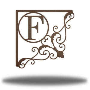 May include: A metal monogram sign with a decorative scroll design. The sign features the letter "F" in a circle.