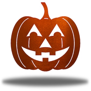 May include: A metal pumpkin with a carved jack-o'-lantern face. The pumpkin is orange and the face is white.