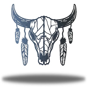 May include: A black metal bull skull with two feathers hanging from each side. The skull is detailed with a cracked pattern and a line down the center.
