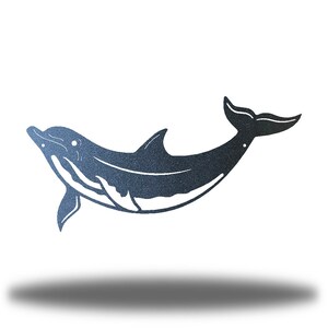 May include: A black metal silhouette of a dolphin leaping out of the water. The dolphin is facing left and has a long, slender body with a curved tail.