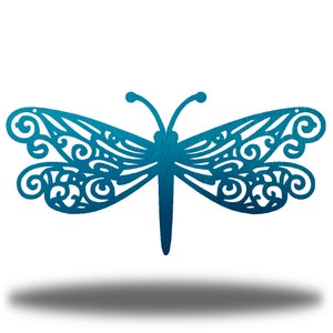 May include: A blue metal dragonfly with intricate cut-out details. The dragonfly has a delicate, lacy design and is a beautiful piece of wall art.
