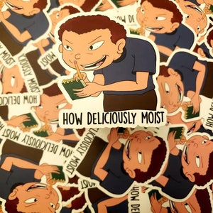 May include: A collection of stickers featuring a cartoon character with brown hair and a blue shirt, holding a pencil and notepad. The stickers have the text "HOW DELICIOUSLY MOIST". The stickers are white with a black border.