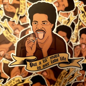 May include: A sticker featuring a cartoon illustration of a man with an afro, wearing a brown jacket and a white shirt, holding a lit joint. The sticker has a yellow banner with the text "Put a lil' mota in our love life".