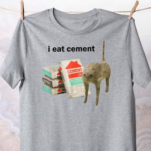 I Eat Cement t-Shirt / Cursed Cat Apparel / Funny Meme Tee / Unhinged Cotton Shirt / Cringe Ugly Clothing / Oddly Ironic Top / Stupid Gift