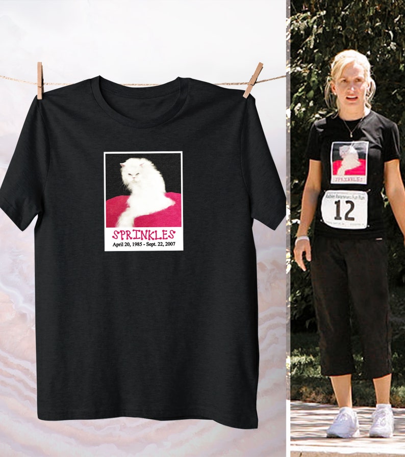 May include: Black t-shirt with a white cat image and the text "SPRINKLES April 20, 1985 - Sept. 22, 2007".