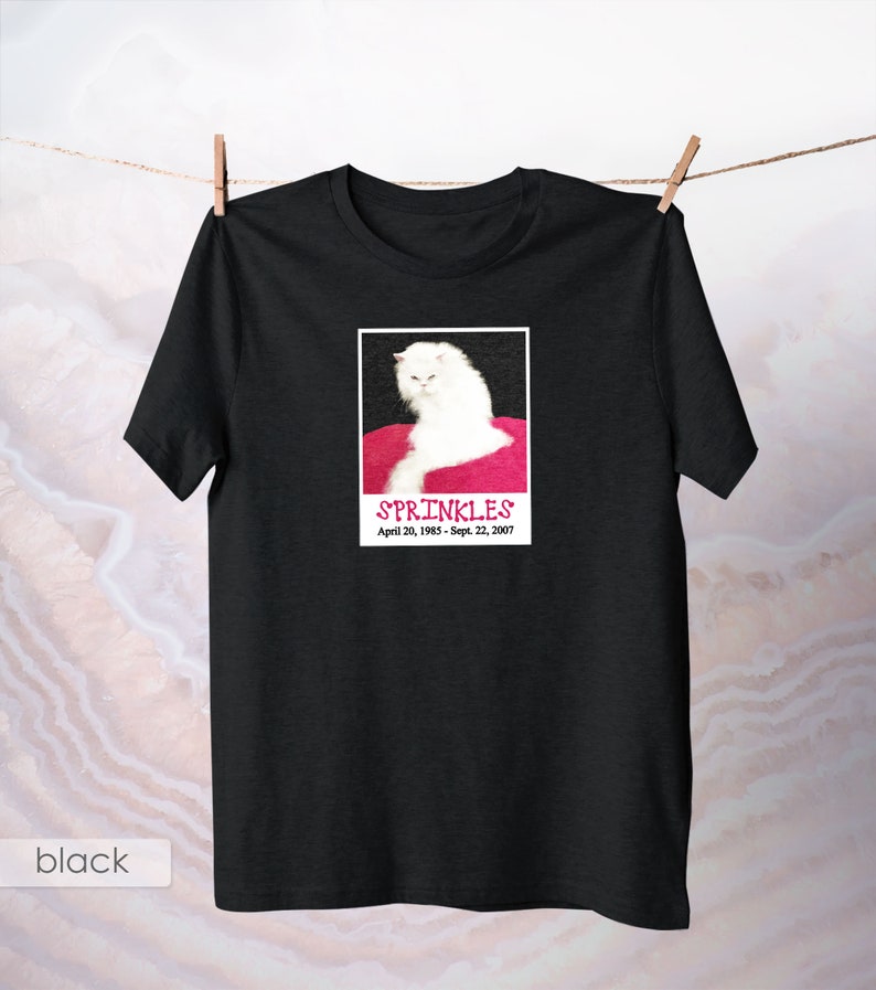 May include: Black t-shirt with a white cat photo and the text "SPRINKLES April 20, 1993 - Sept. 22, 2007"